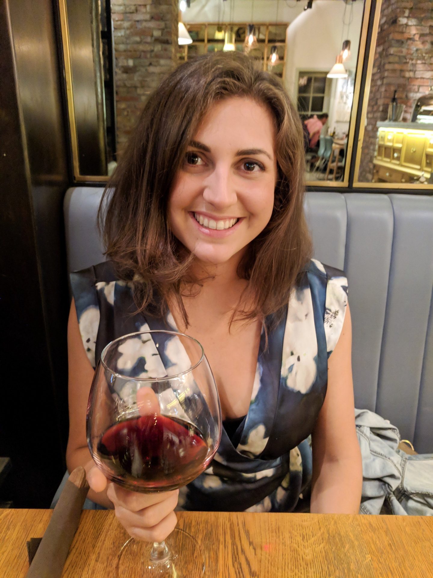 Girl with large glass of wine in restaurant in Cluj, Romanina
