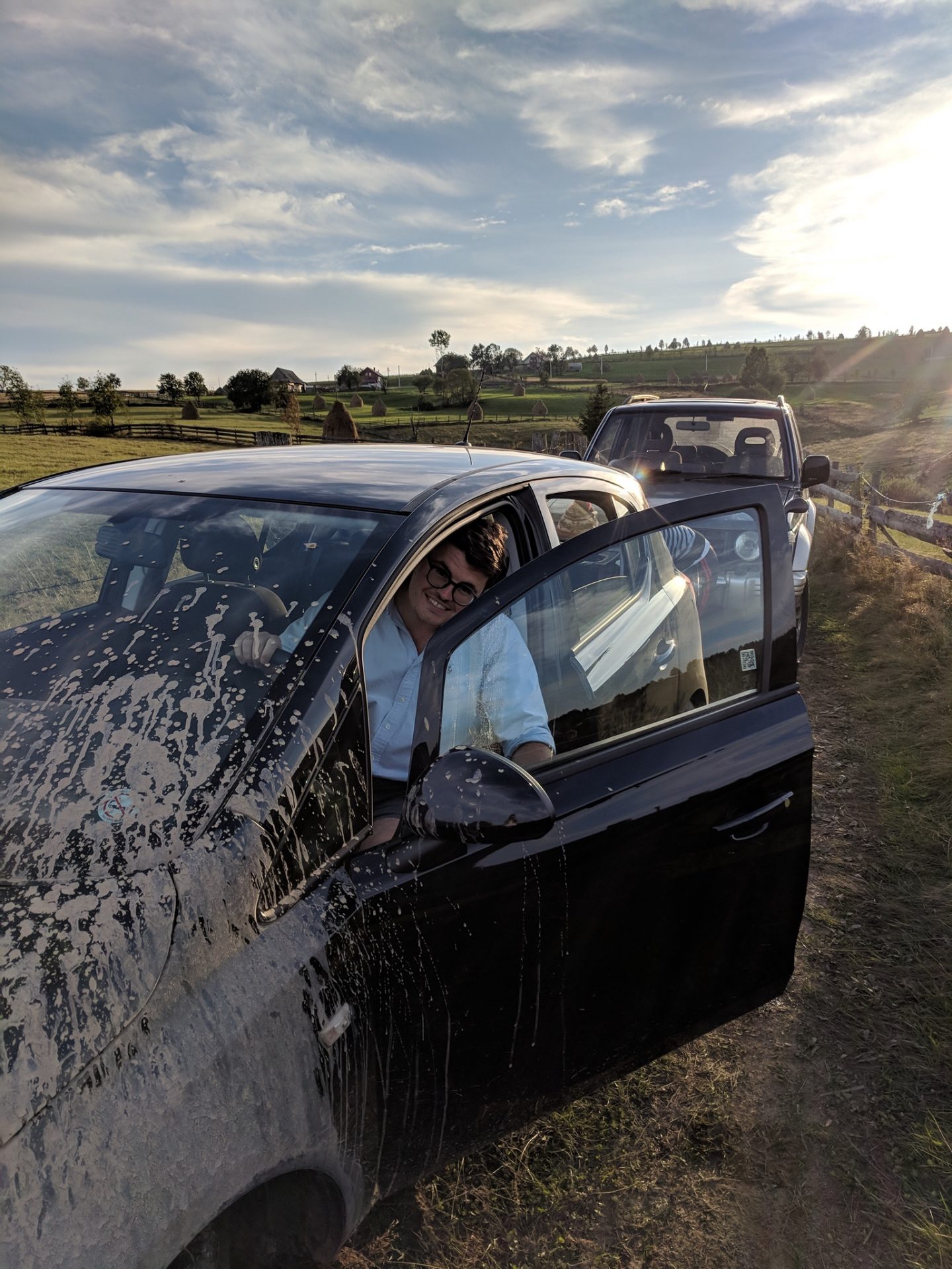 Billy in a very muddy car, whilst stuck in a muddy puddle.