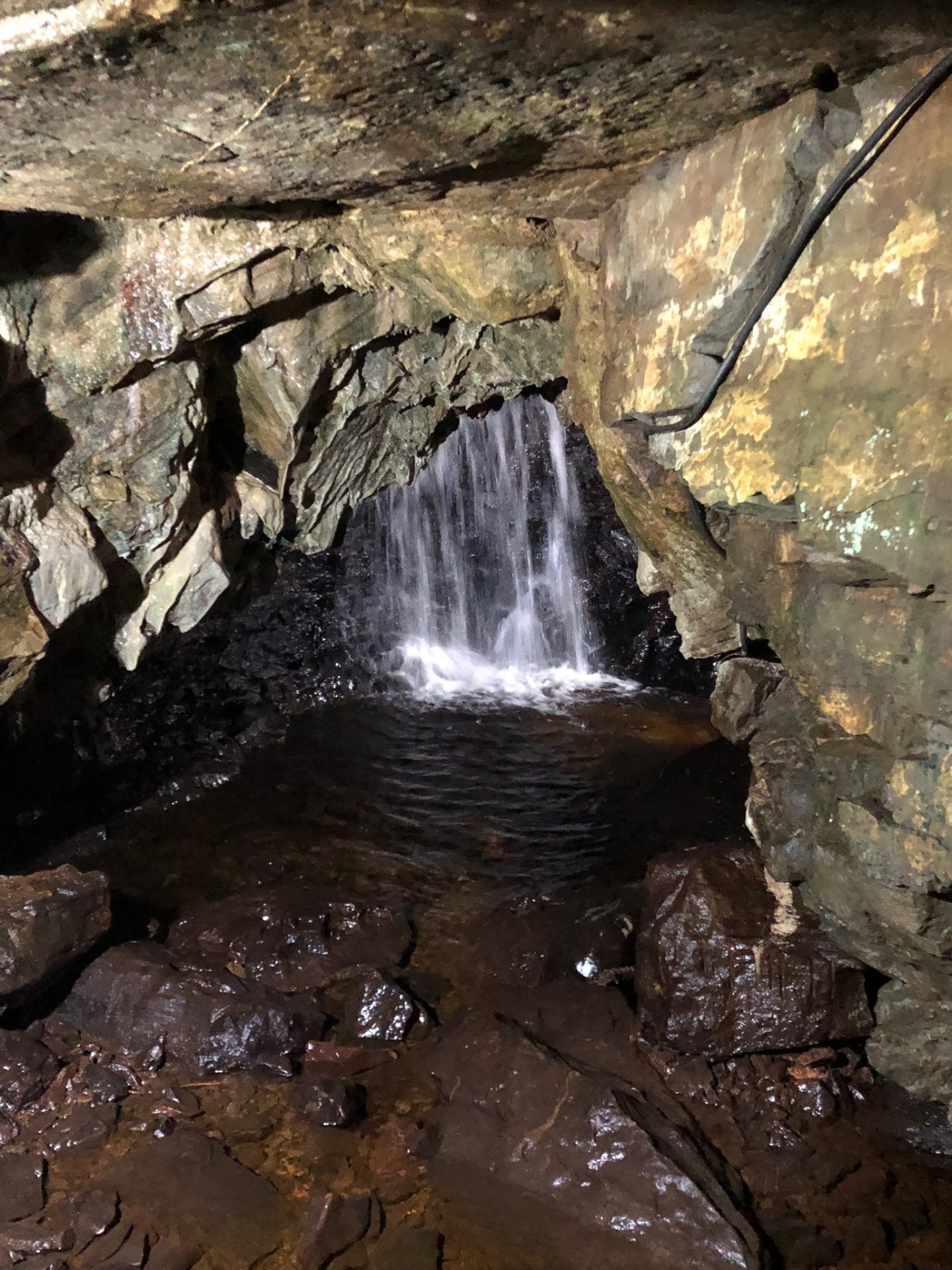 an image of a waterfall inside white scar caves