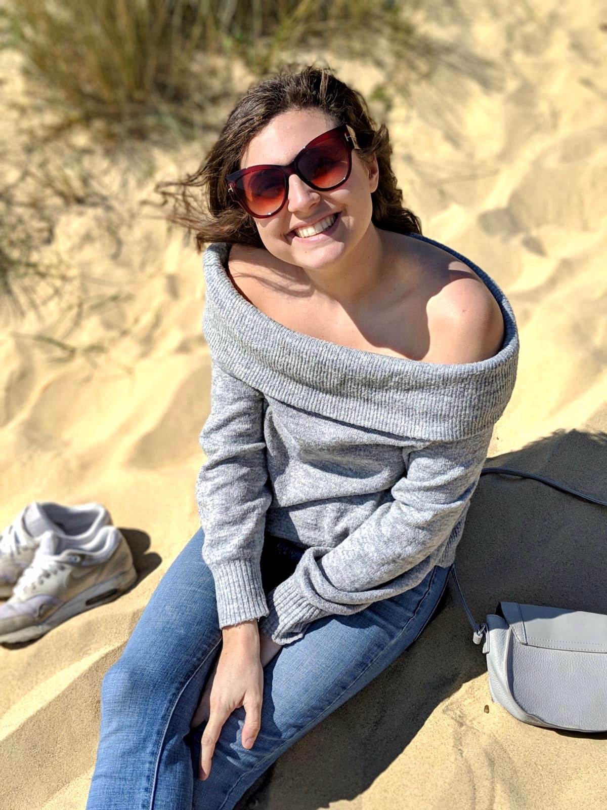 Things to do in Southwold: Nell sand on a sandy beach smiling up at the camera
