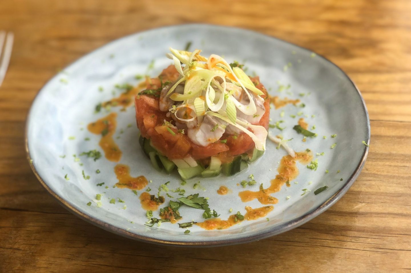 Ceviche fish beautifully presented on a papaya and cucumber salad in Gran Canaria