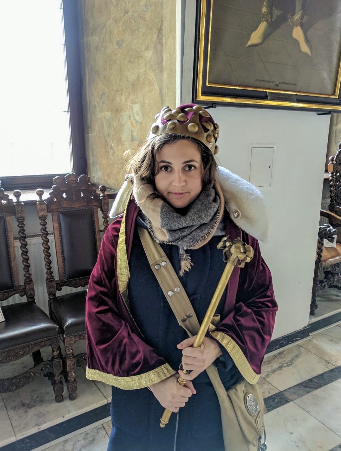 Girl in a museum on a cheap city break in Gdansk dressed up in a crown