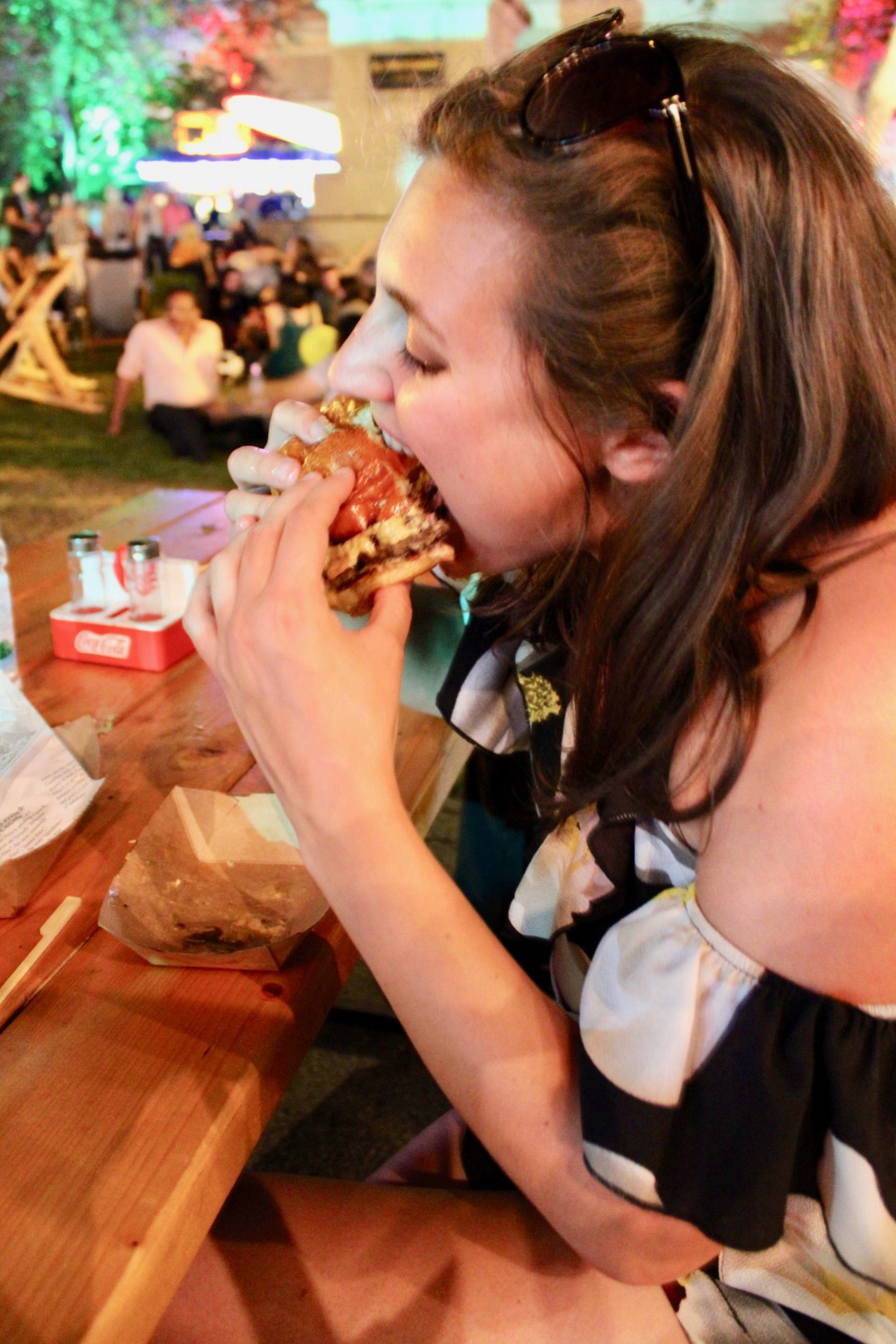 Nell eating a burger at Zagreb burger festival during our Istanbul to Venice itinerary 