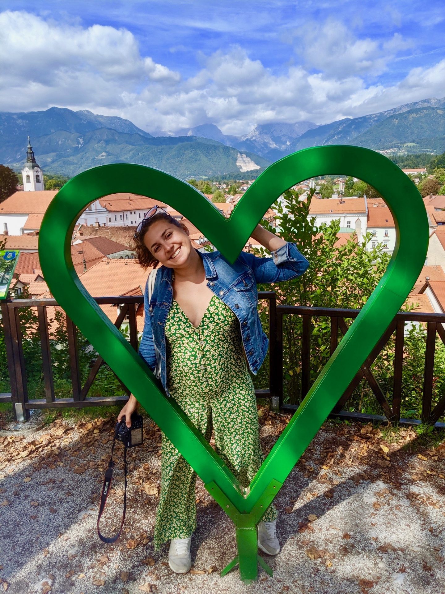 Kamnik and Velika Planina: Nell posing in a feel slovenia love heart with views of Kamnik and the alps in the background