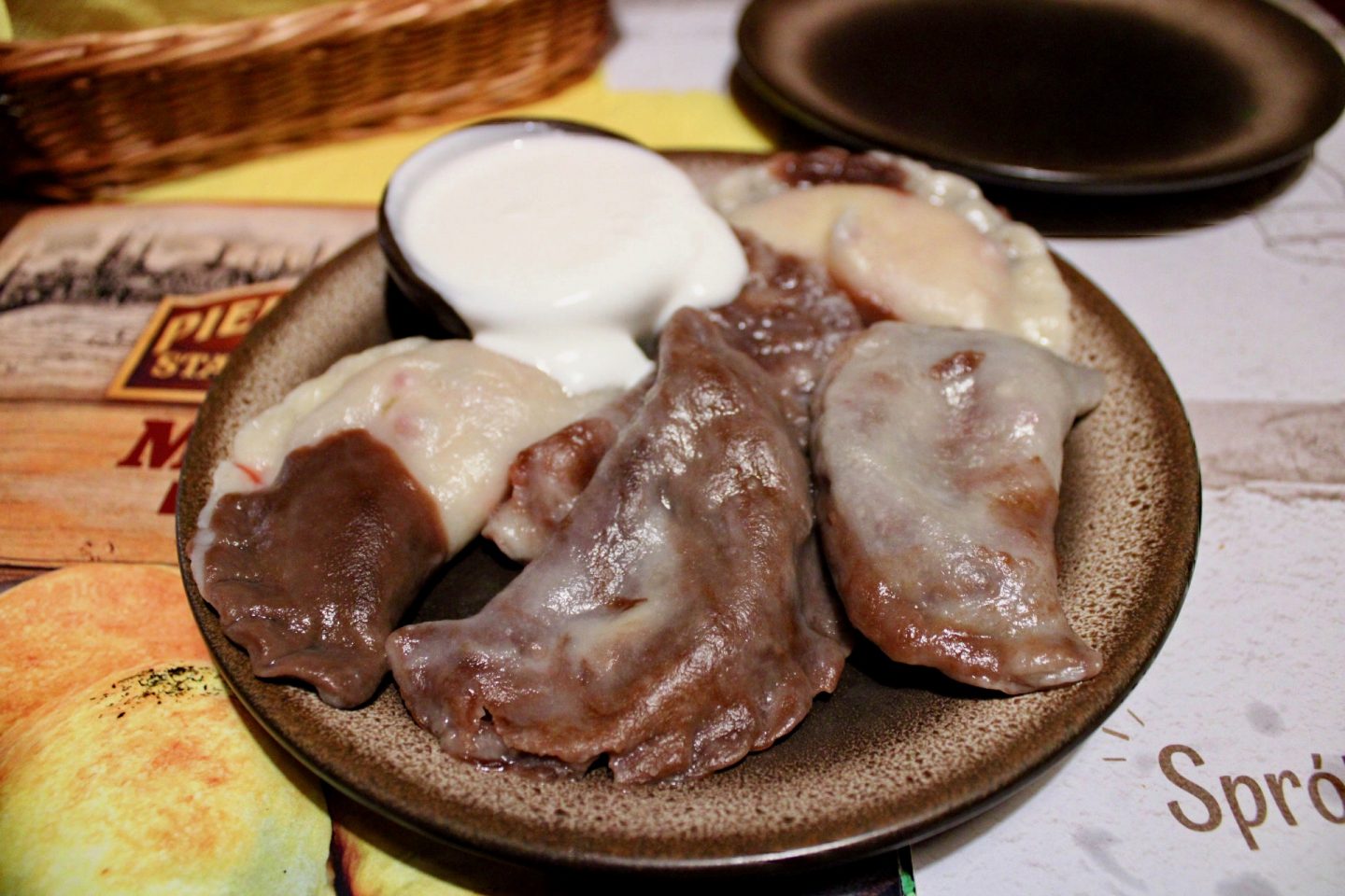 best bars restaurants in Wroclaw - a plate of sweet pierogies which are a mixture of dark and white chocolate