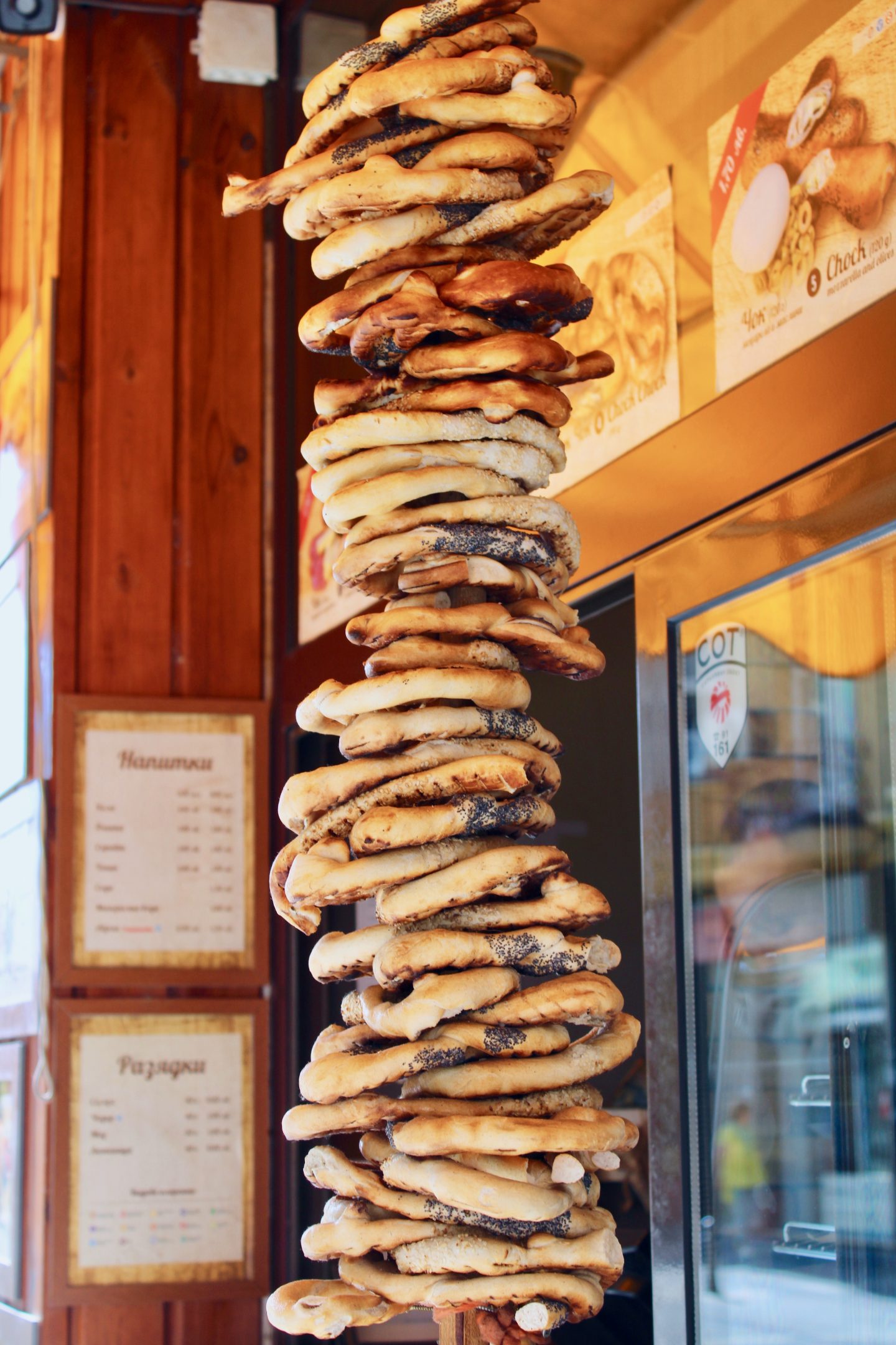 traditional bulgarian food in sofia: circular bread hanging outside the window of a bakery