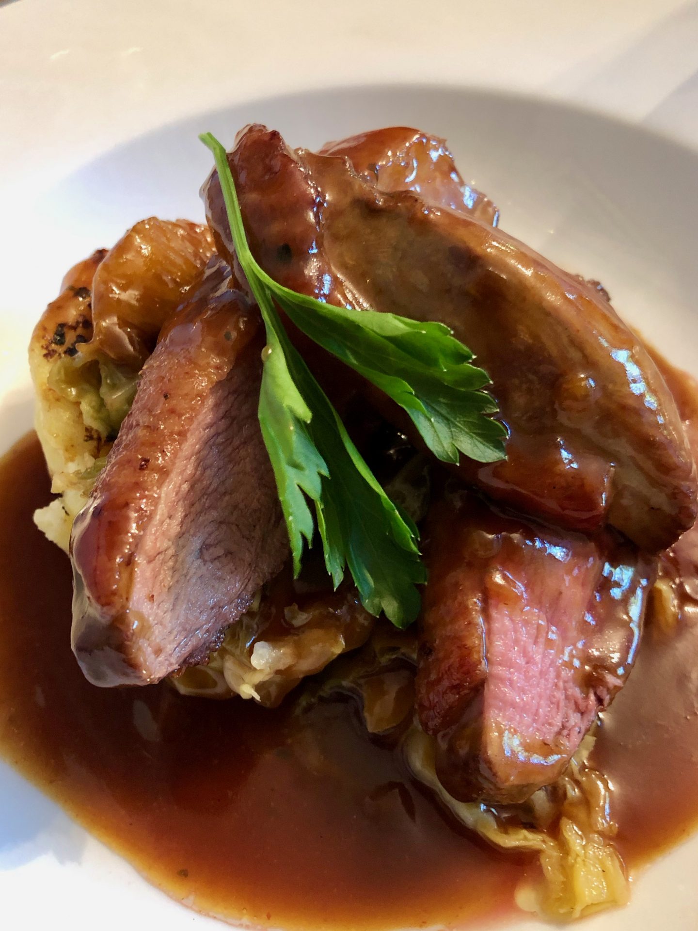 crib goch route up snowdon: a plate of duck breast with a rich sauce on a white plate