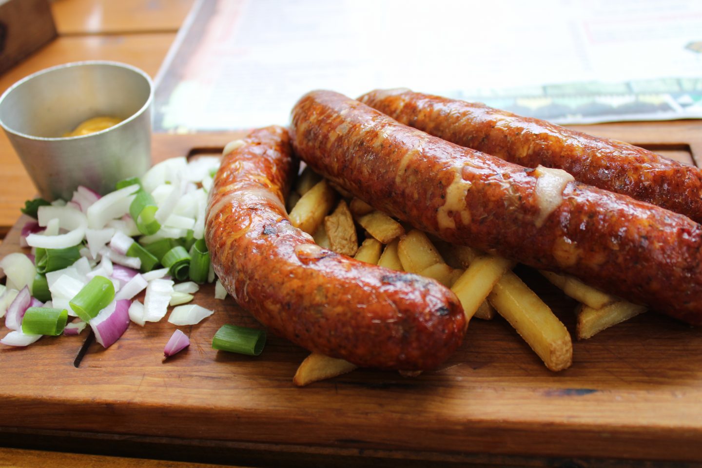 visit belgrade - smoked sausages on a wooden platter 