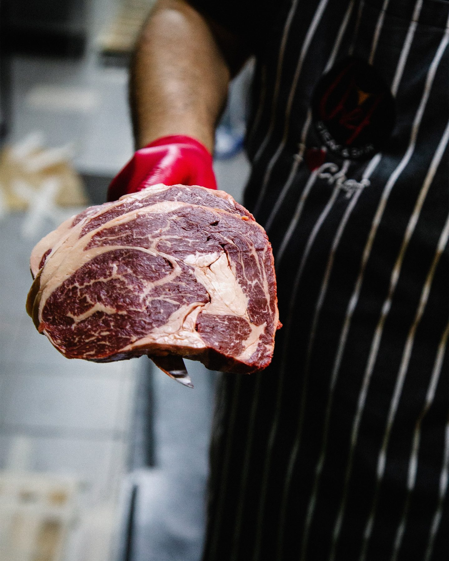 Best foodie subscription boxes: a butcher holding a cut of beef on a knife